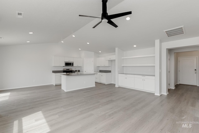 5754 W Stavros St, Meridian, ID 83646 - unfurnished living room with a sink, vaulted ceiling, ceiling fan, recessed lighting, and baseboards