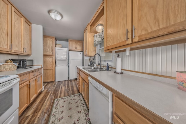 1035 N 7th Ave N, Payette, ID 83661 - kitchen with white appliances, a sink, estacked washer and dryer, dark wood-style floors, and light countertops