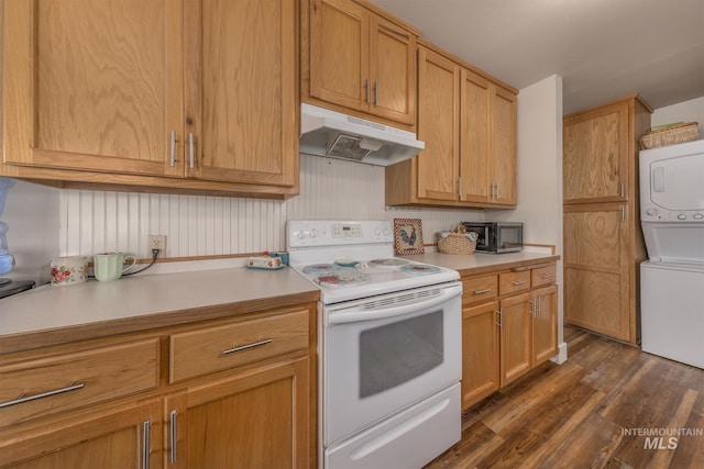 1035 N 7th Ave N, Payette, ID 83661 - kitchen with white range with electric stovetop, under cabinet range hood, stacked washer / dryer, light countertops, and dark wood-style flooring