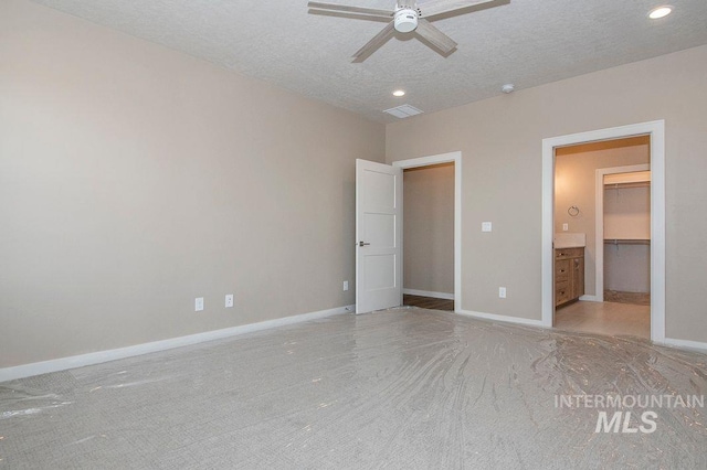 unfurnished bedroom featuring visible vents, baseboards, a textured ceiling, and recessed lighting