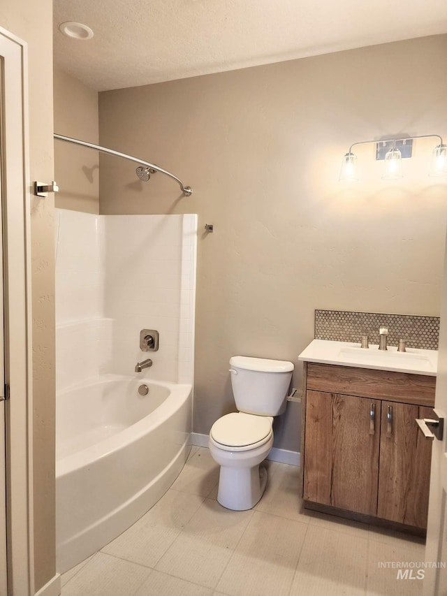 full bathroom with shower / bathtub combination, toilet, vanity, tile patterned flooring, and baseboards