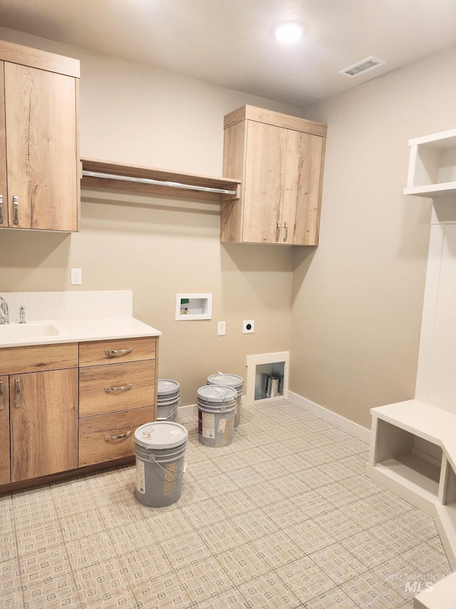 laundry area featuring washer hookup, a sink, visible vents, baseboards, and electric dryer hookup