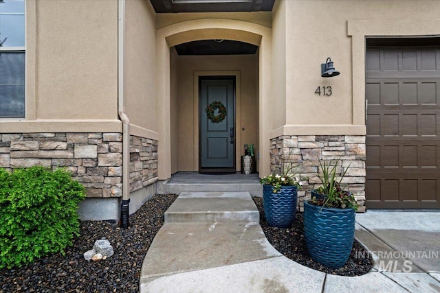 view of exterior entry with a garage