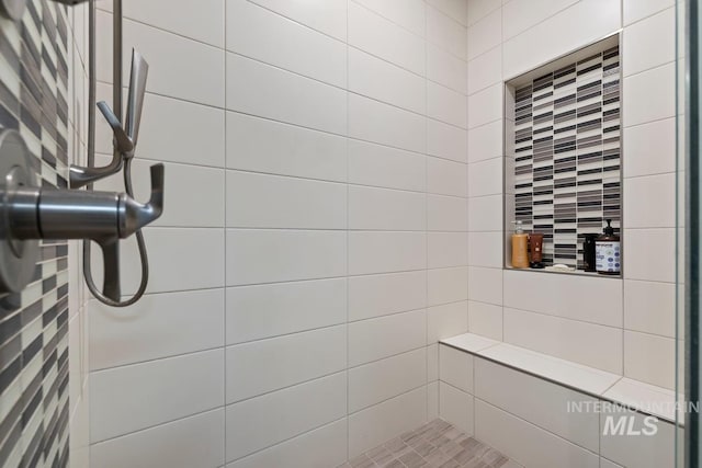 bathroom with a tile shower