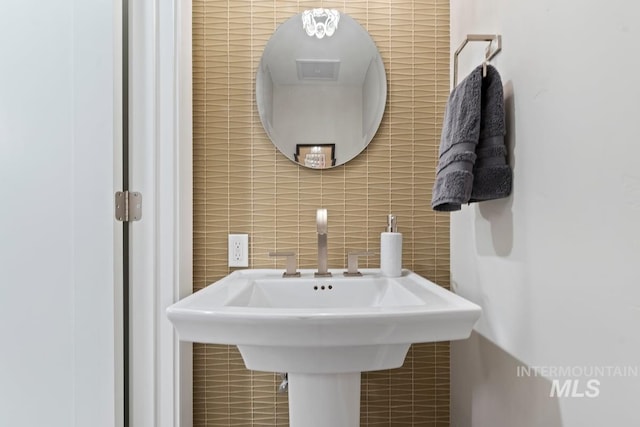 bathroom with tile walls and decorative backsplash