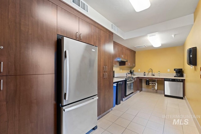 kitchen featuring a sink, light tile patterned flooring, visible vents, light countertops, and appliances with stainless steel finishes