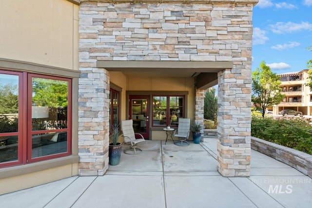 exterior space featuring french doors and stone siding