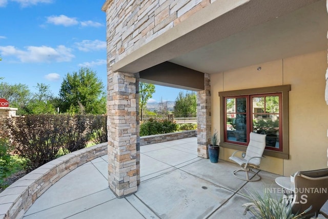view of patio / terrace featuring fence