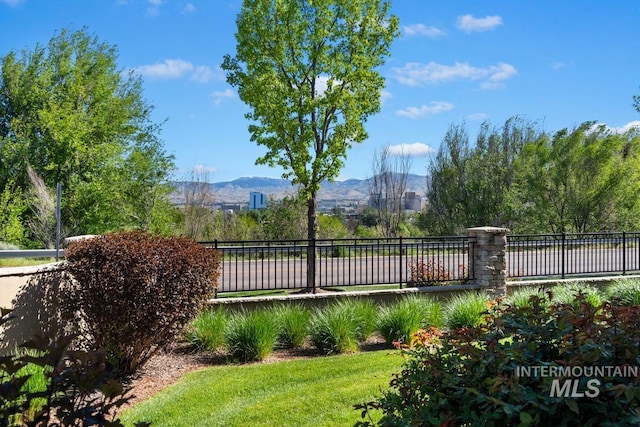 view of yard with a mountain view and fence