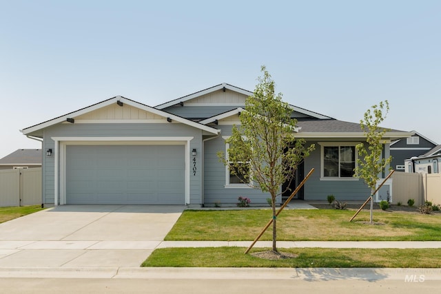 view of front of property featuring a front yard and a garage