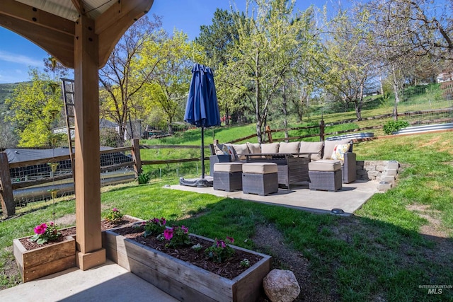 view of yard featuring an outdoor living space, a patio, and fence