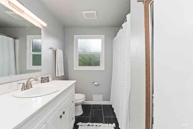 bathroom featuring vanity and toilet