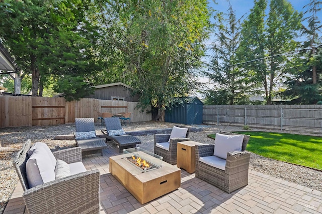 view of patio / terrace with a storage unit and an outdoor living space with a fire pit