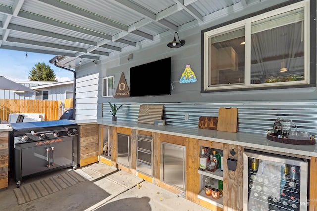 view of patio featuring wine cooler and a grill