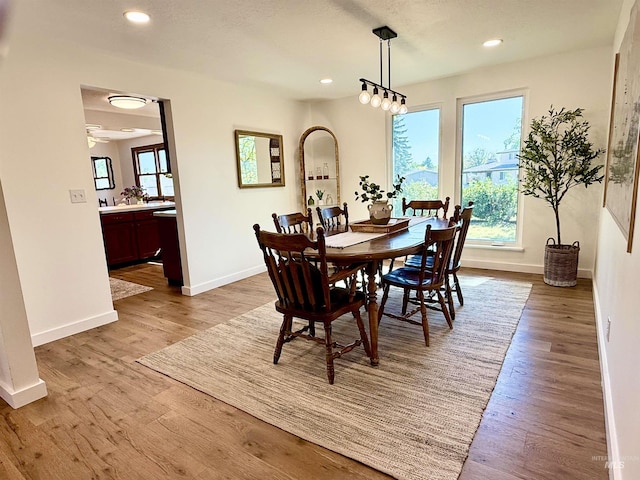 dining area with baseboards, recessed lighting, and wood finished floors