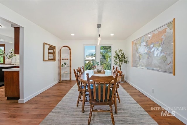 dining space featuring recessed lighting, baseboards, plenty of natural light, and wood finished floors
