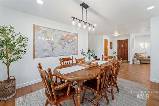 dining area with recessed lighting, baseboards, and wood finished floors