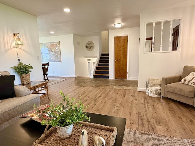 living area featuring stairway, baseboards, recessed lighting, and wood finished floors