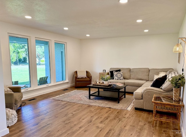 living area featuring recessed lighting, baseboards, visible vents, and light wood-style flooring