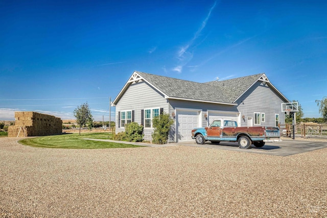 27652 Hop Rd, Caldwell, ID 83607 - view of side of home with driveway, roof with shingles, fence, a yard, and an attached garage