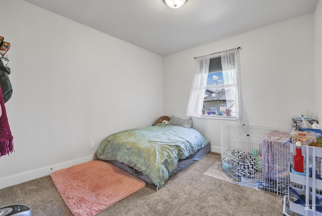 carpeted bedroom with baseboards