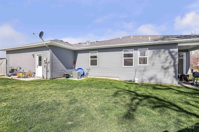 back of house featuring a yard, a patio, and central air condition unit