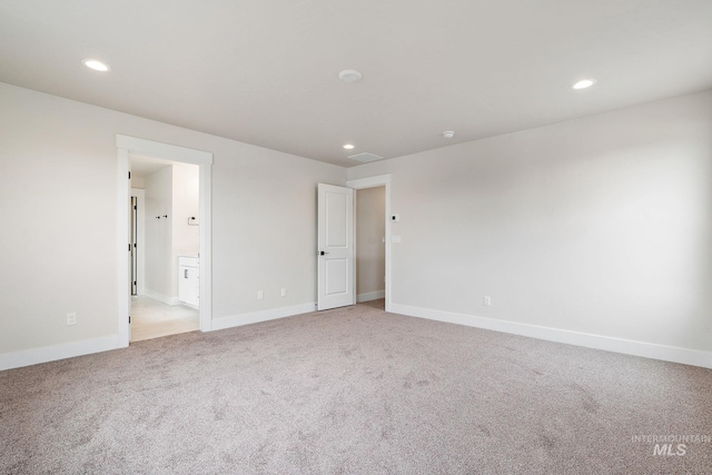 unfurnished bedroom featuring light colored carpet, visible vents, and recessed lighting