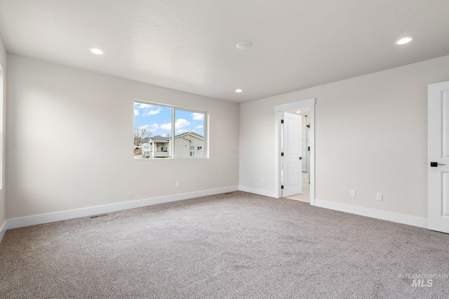 carpeted empty room with visible vents, baseboards, and recessed lighting