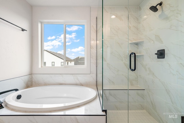 full bath featuring a garden tub and a shower stall