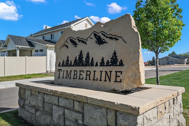 community / neighborhood sign with fence