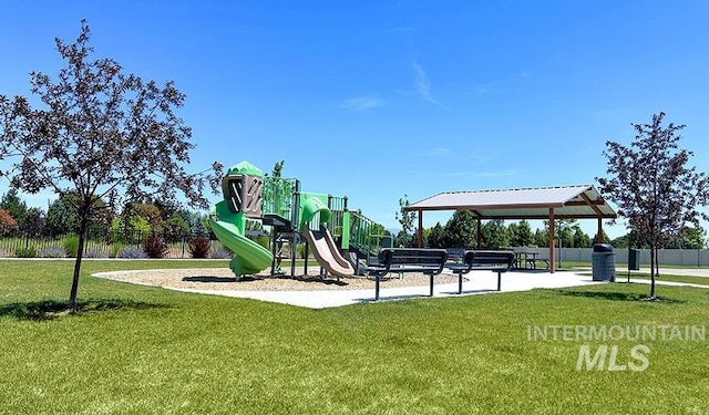 community jungle gym with fence and a yard