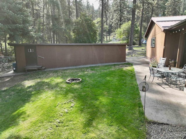 view of yard with a shed and a patio area