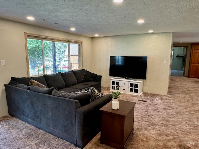 carpeted living room featuring a textured ceiling