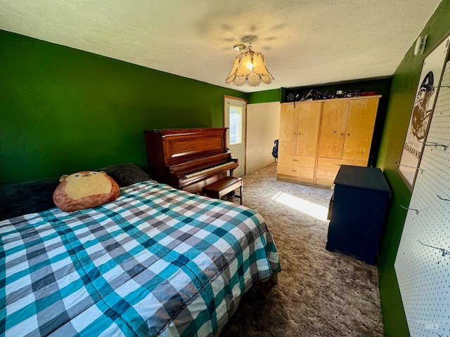 carpeted bedroom featuring a textured ceiling