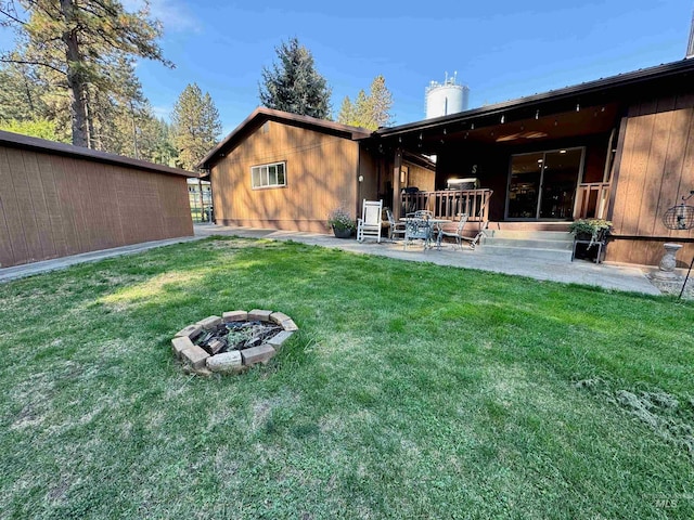 view of yard featuring a patio and an outdoor fire pit