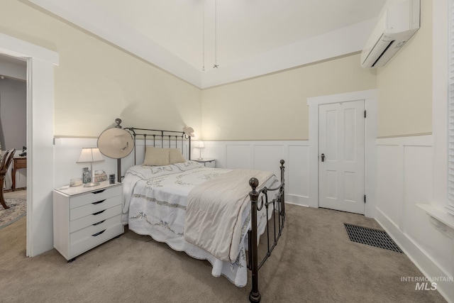 carpeted bedroom with an AC wall unit