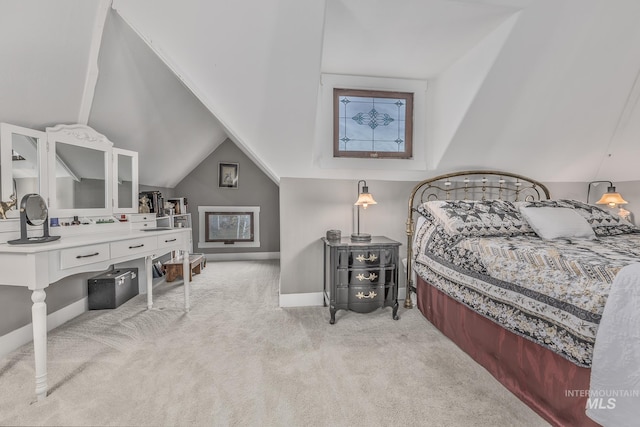 carpeted bedroom with vaulted ceiling