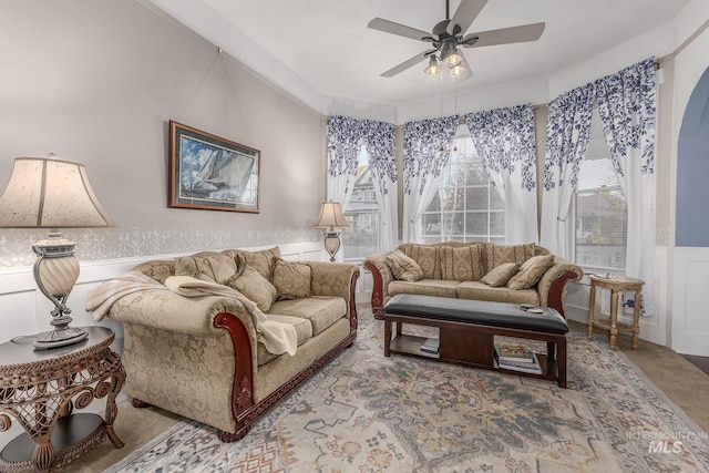 living room with ceiling fan and crown molding