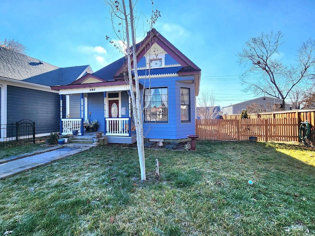 view of front of house featuring covered porch and a front lawn