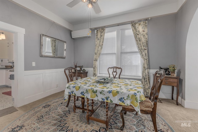 carpeted dining space with a wall mounted AC and ceiling fan