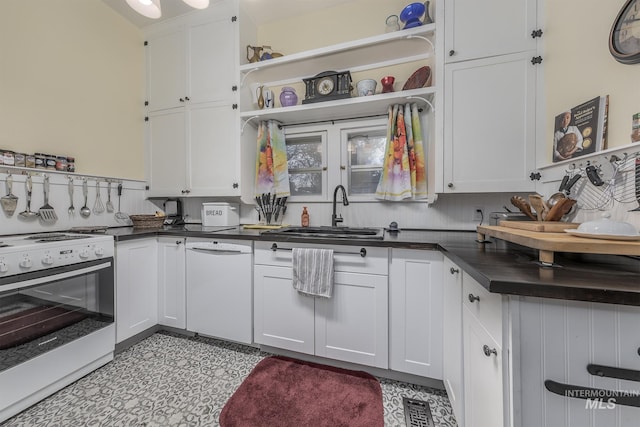 kitchen featuring white cabinetry, white appliances, sink, and tasteful backsplash