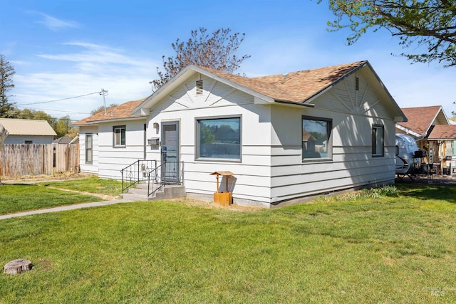 bungalow-style house featuring roof with shingles
