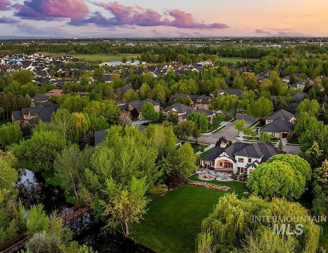 aerial view of residential area with a tree filled landscape