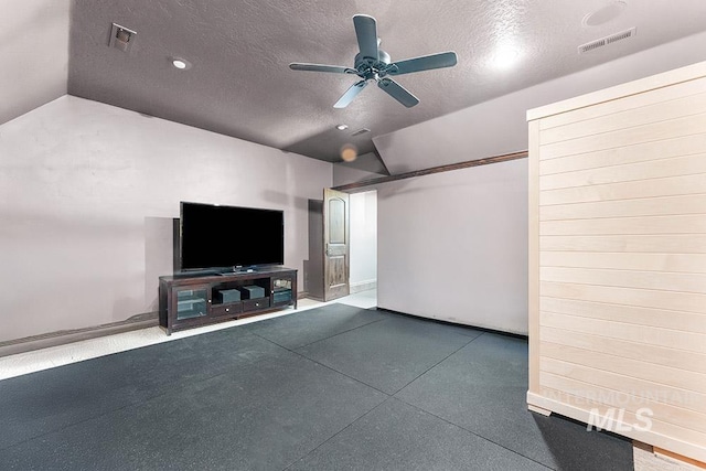unfurnished living room with ceiling fan, a textured ceiling, and vaulted ceiling