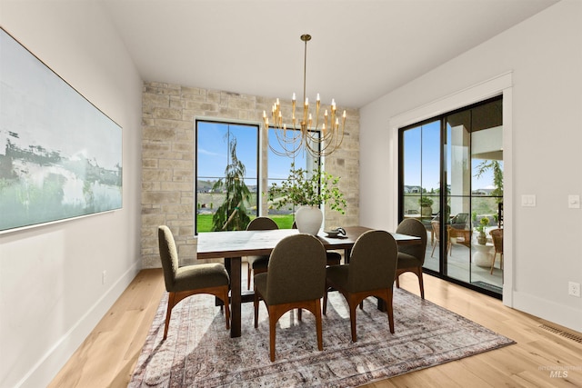 11473 N 17th Way, Boise, ID 83714 - dining area with light wood-style floors, a chandelier, and baseboards