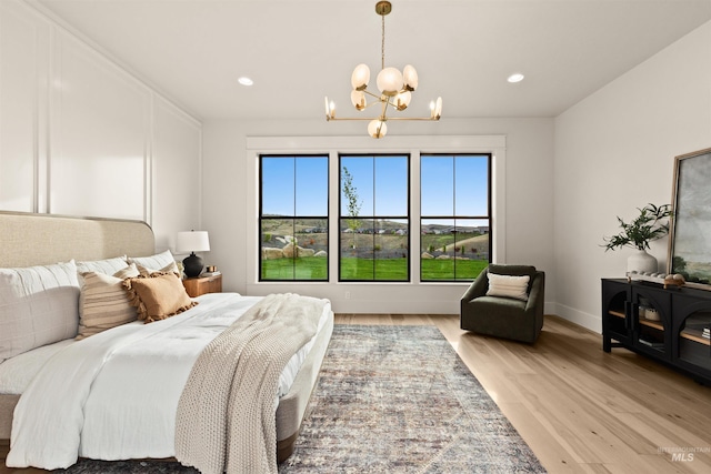 11473 N 17th Way, Boise, ID 83714 - bedroom with a chandelier, light wood-type flooring, recessed lighting, and baseboards