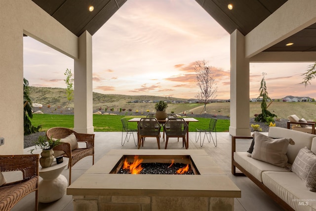 11473 N 17th Way, Boise, ID 83714 - patio terrace at dusk with an outdoor living space with a fire pit and a lawn
