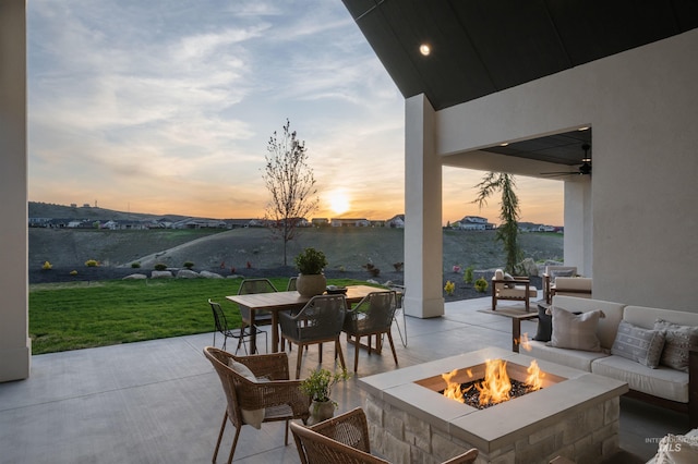 11473 N 17th Way, Boise, ID 83714 - patio terrace at dusk featuring a lawn, outdoor dining space, and an outdoor living space with a fire pit