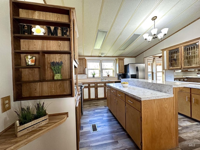 kitchen with lofted ceiling, decorative light fixtures, dark hardwood / wood-style floors, a notable chandelier, and stainless steel fridge with ice dispenser