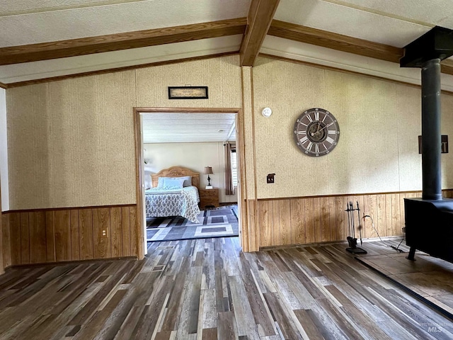 corridor with dark hardwood / wood-style flooring and lofted ceiling with beams